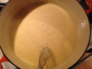 Mixing the roux (butter and flour thickener) into the milk