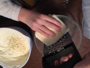 My son helping to grate the cheese