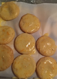 Orange cookies packed for freezing with parchment layers